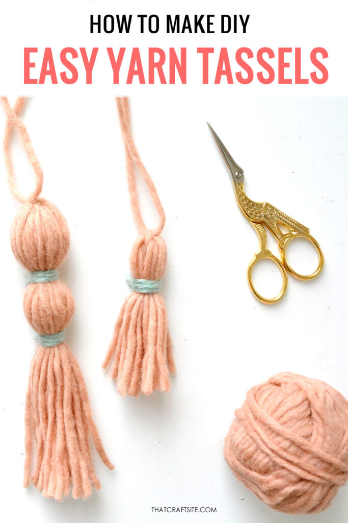 Handmade pink yarn tassels and gold stork bird scissors. Text on image: How to make DIY easy yarn tassels. thatcraftsite.com