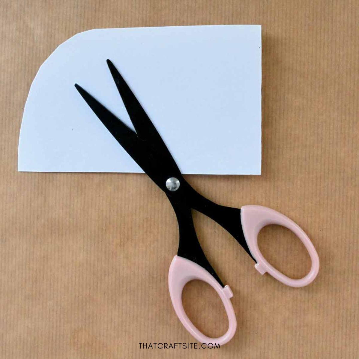DIY Cylinder Christmas Reindeer Gift Wrap. Step 2: Cut a curve on a white paper strip folded in half.